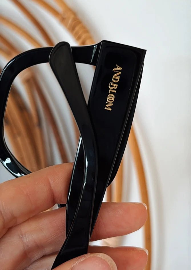 Close-up of Gaia sunglasses – AndBloom, sleek frame detail in natural light
