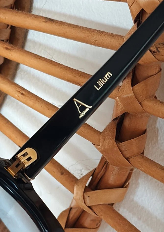 Overhead shot of Lilium sunglasses – AndBloom, flatlay on neutral surface