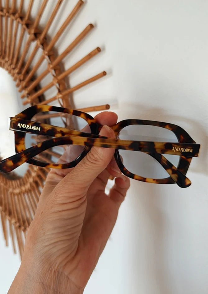 Phlox sunglasses by AndBloom – close-up of matte tortoise frame with bold blue lenses, stylish eyewear for women 35+